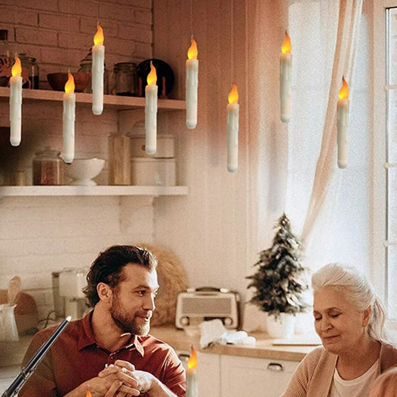 A single floating LED taper candle illuminated, highlighting its realistic flickering effect