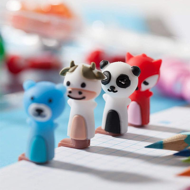 Kids using ergonomic pencil grips during a writing activity, showing posture correction benefits