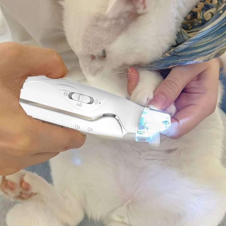 User happily grooming their dog with the 2-in-1 nail grinder & LED light engaged