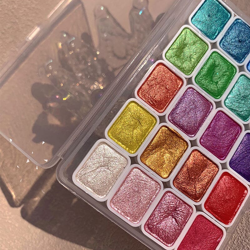 Art studio scene with the 20-color metallic watercolor painting set and brushes, inspiring creative art.