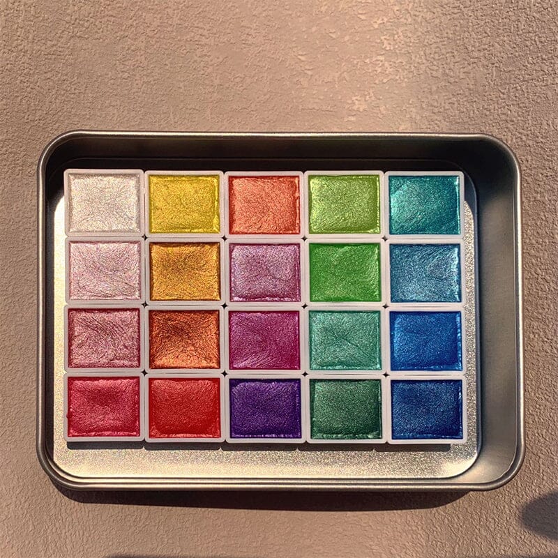 Variety of metallic watercolors from the 20-color set, demonstrating their unique shimmering quality for art.