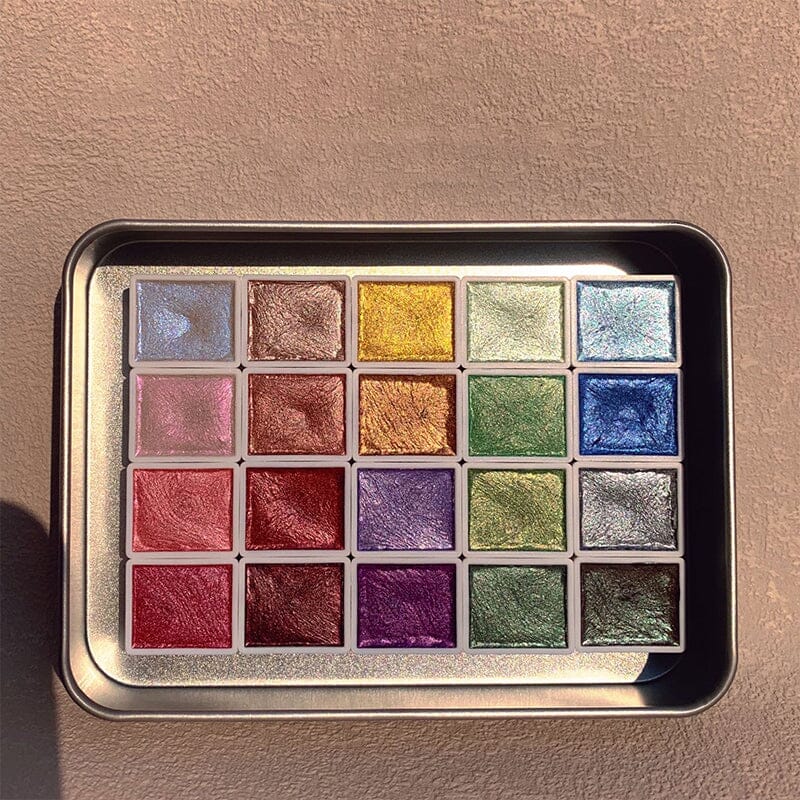 The 20-color metallic watercolor set beside a finished artwork, highlighting the beautiful shimmer paints.