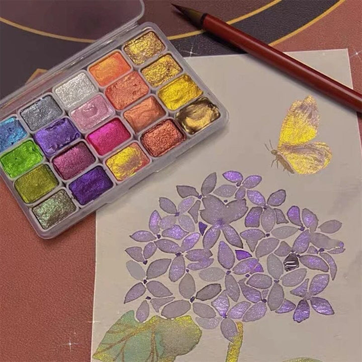 Artist's hand demonstrating the vibrant metallic watercolors from the 20-color painting set, great for creative art.