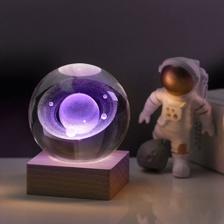 Crystal galaxy sphere night light, desktop decor with planets and stars, illuminated by a warm LED glow