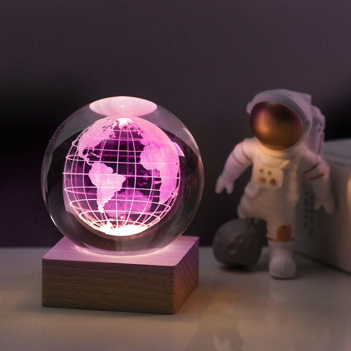 Crystal ball night light displaying a vibrant 3D galaxy, creating an ambient glow for any room