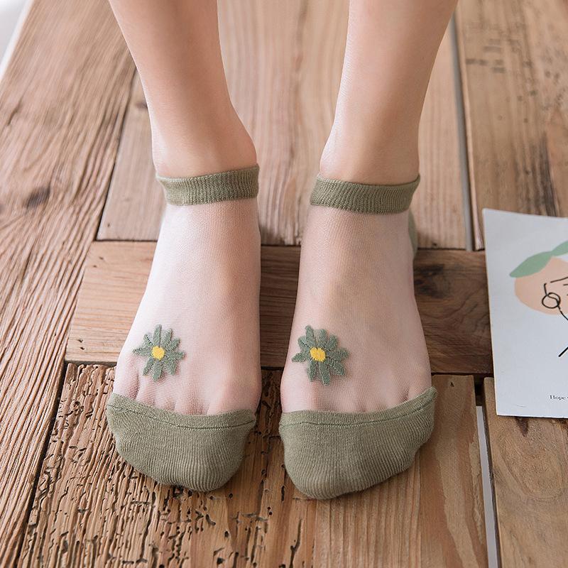 Collection of women's summer ankle socks, each pair featuring a distinctive daisy floral motif