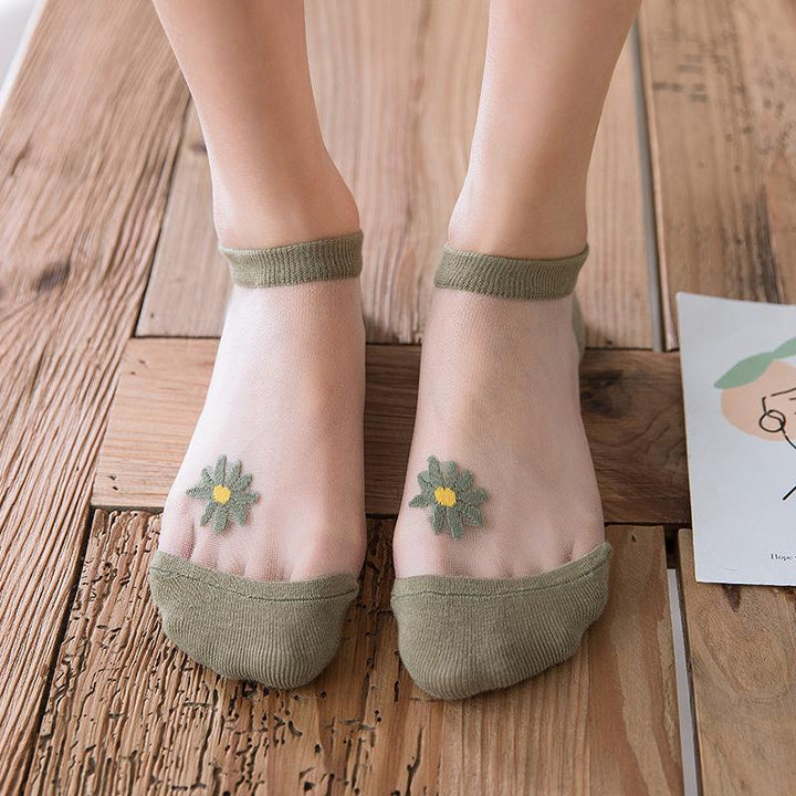 Collection of women's summer ankle socks, each pair featuring a distinctive daisy floral motif