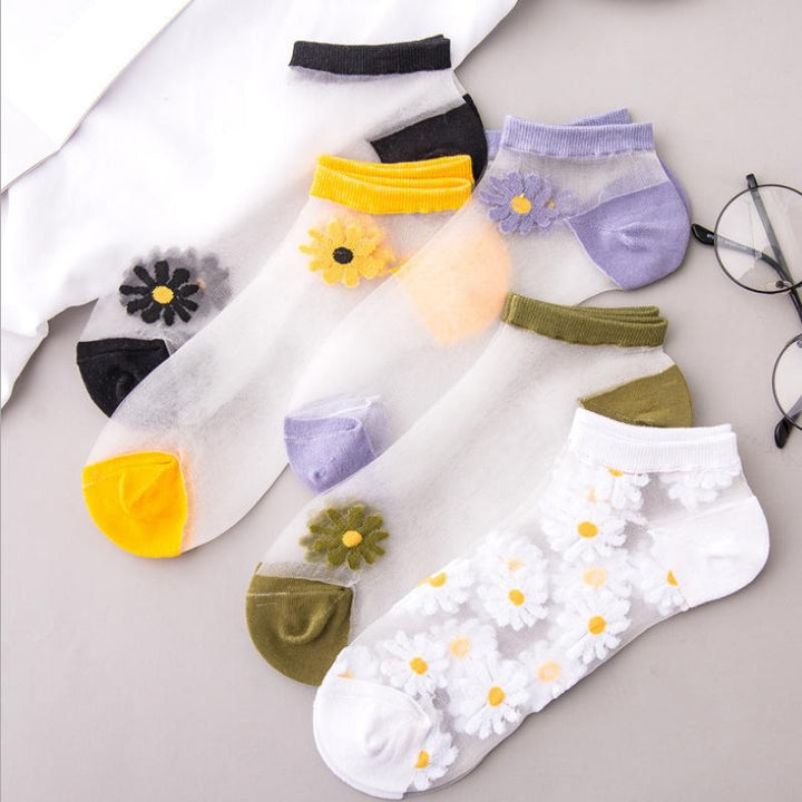 Stack of colorful women's floral daisy ankle socks in various shades