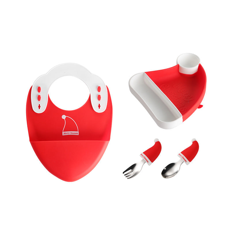 Toddler enjoying a meal using the suction plate and baby utensil set, promoting independence
