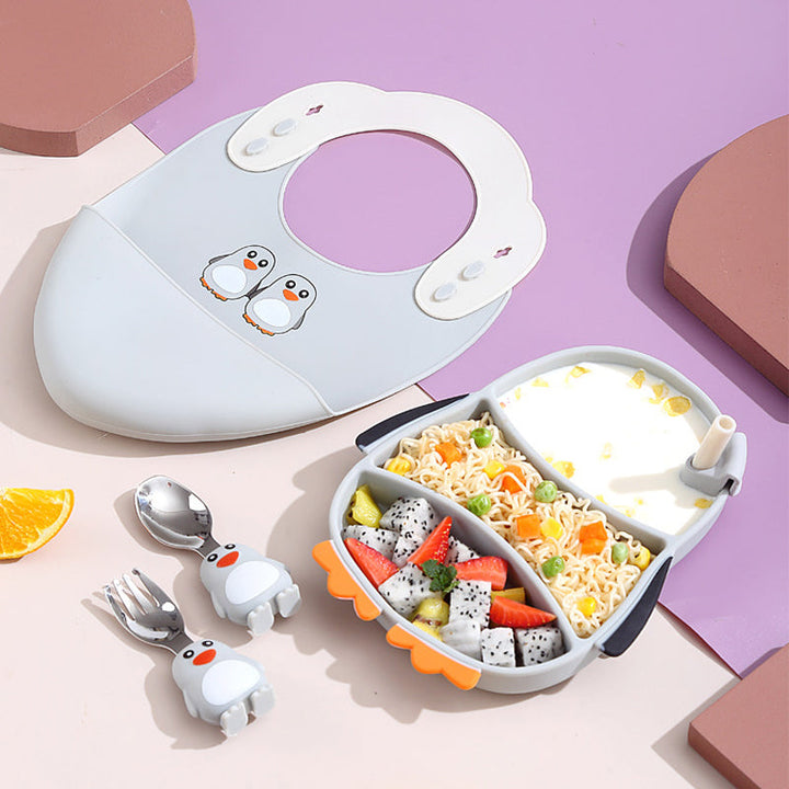 A toddler happily using the suction plate and utensil set, promoting independent baby self-feeding