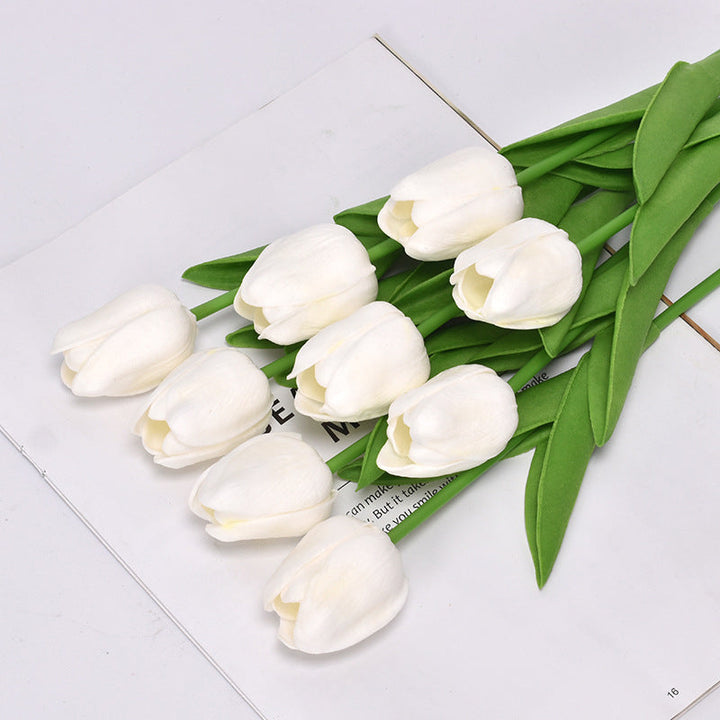 Artificial tulip flowers bundled together, ready for creative floral displays