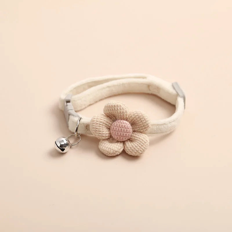 "Adjustable cat collar with floral pattern and bell, featuring earth tones and pastels for style and comfort."