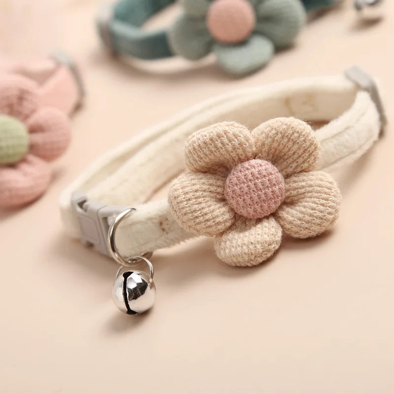 "Adjustable cat collar with floral pattern and bell, featuring earth tones and pastels for style and comfort."