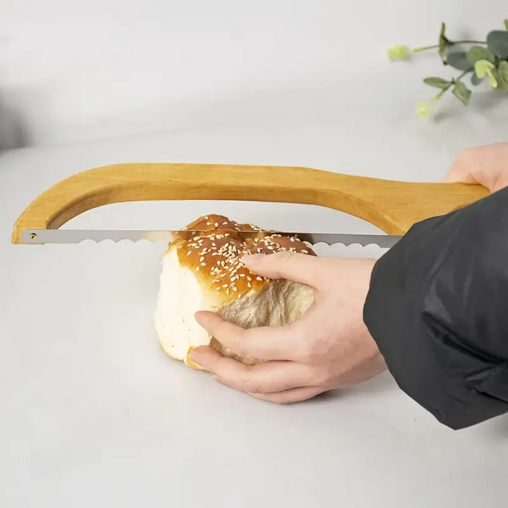 "Bamboo-handled stainless steel bread bow cutter, elegant design, perfect for slicing fresh bread with precision and style."