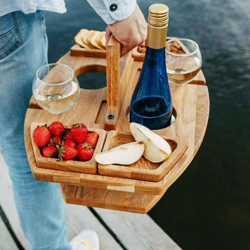 Compact wooden picnic wine table with compartments for snacks and wine, featuring a foldable, elegant design for outdoor gath