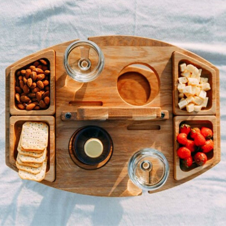 Compact wooden picnic wine table with compartments for snacks and wine, featuring a foldable, elegant design for outdoor gath