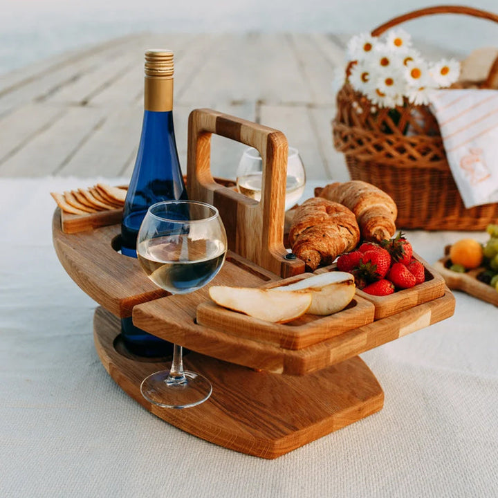 Compact wooden picnic wine table with compartments for snacks and wine, featuring a foldable, elegant design for outdoor gath