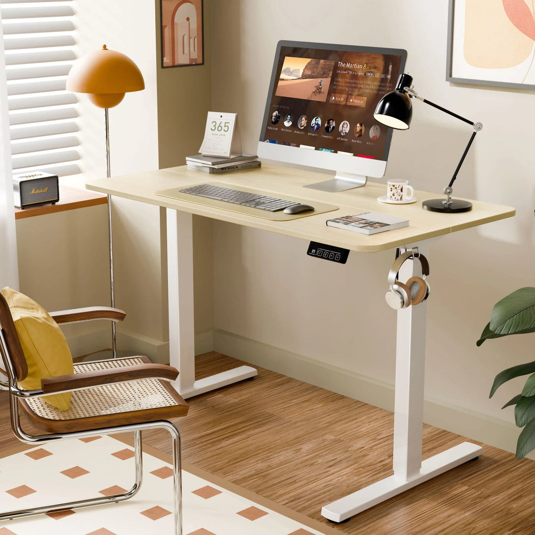 "Electric height adjustable sit-stand computer desk with spacious surface for ergonomic home or office use."