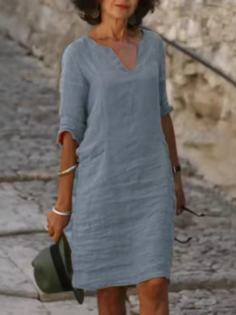 Elegant slim fit V-neck cotton linen dress with mid sleeves, perfect for warm weather. Shop women's dresses for all occasions