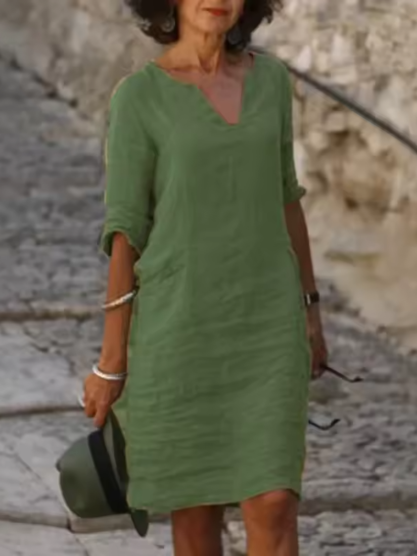 Elegant slim fit V-neck cotton linen dress with mid sleeves, perfect for warm weather. Shop women's dresses for all occasions