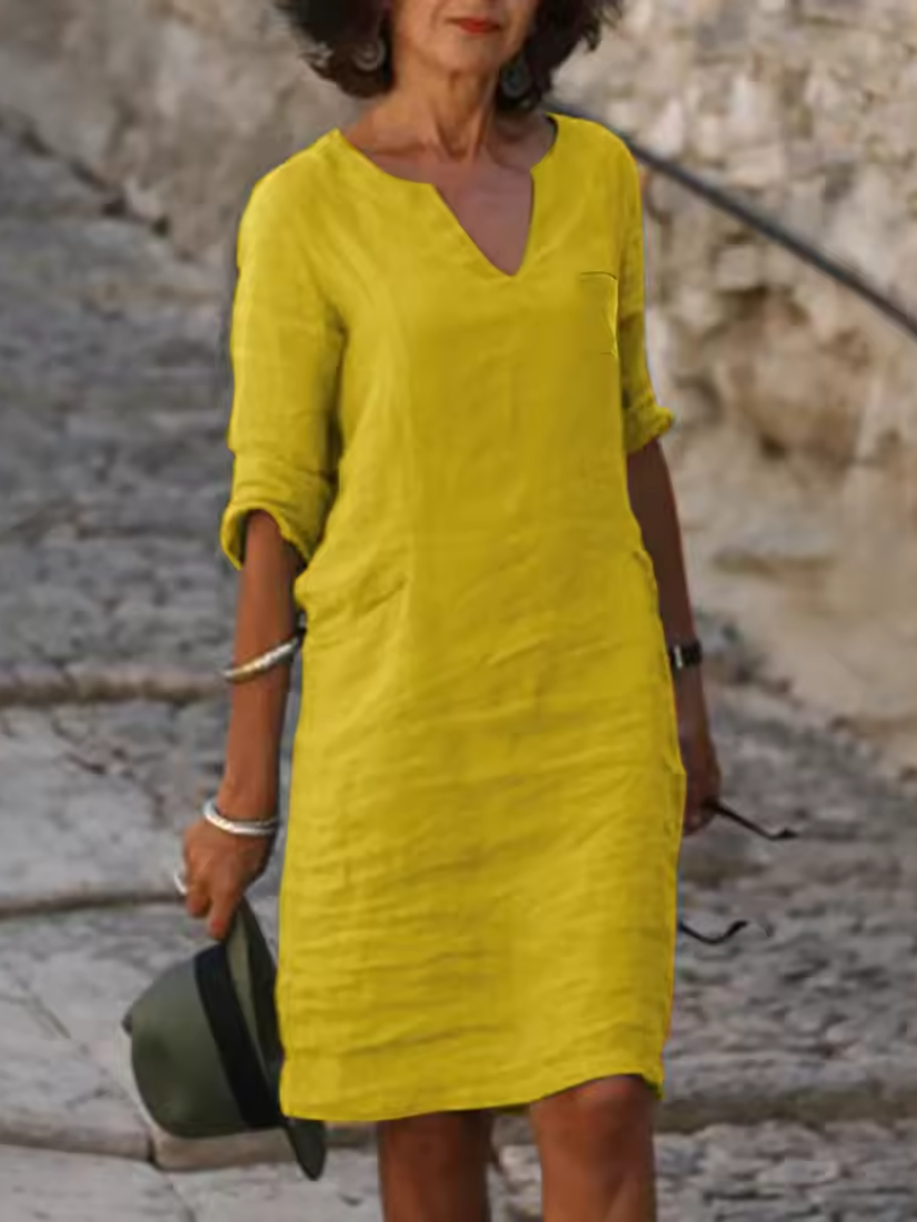 Elegant slim fit V-neck cotton linen dress with mid sleeves, perfect for warm weather. Shop women's dresses for all occasions