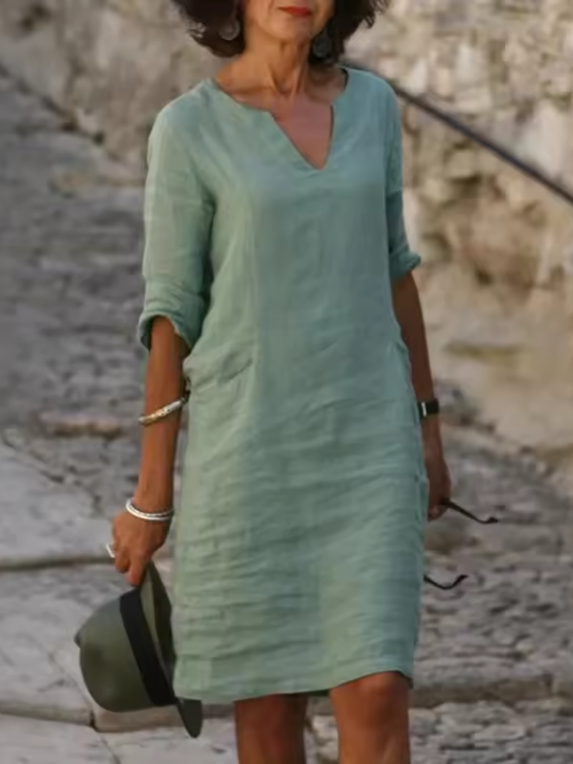 Elegant slim fit V-neck cotton linen dress with mid sleeves, perfect for warm weather. Shop women's dresses for all occasions