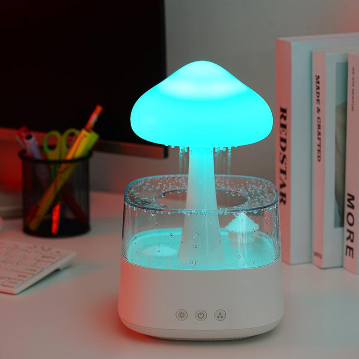 "Elegant white humidifier with wooden finish, emits soothing mist and rain sounds for relaxation and improved sleep."