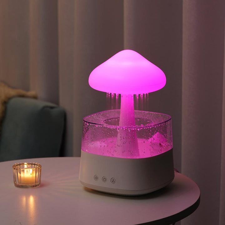 "Elegant white humidifier with wooden finish, emits soothing mist and rain sounds for relaxation and improved sleep."