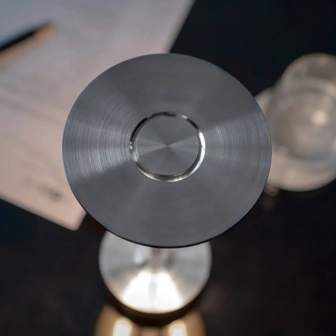 "Elegant wireless table lamp with sleek curves, gold finish; perfect for versatile ambient lighting on any table or desk."