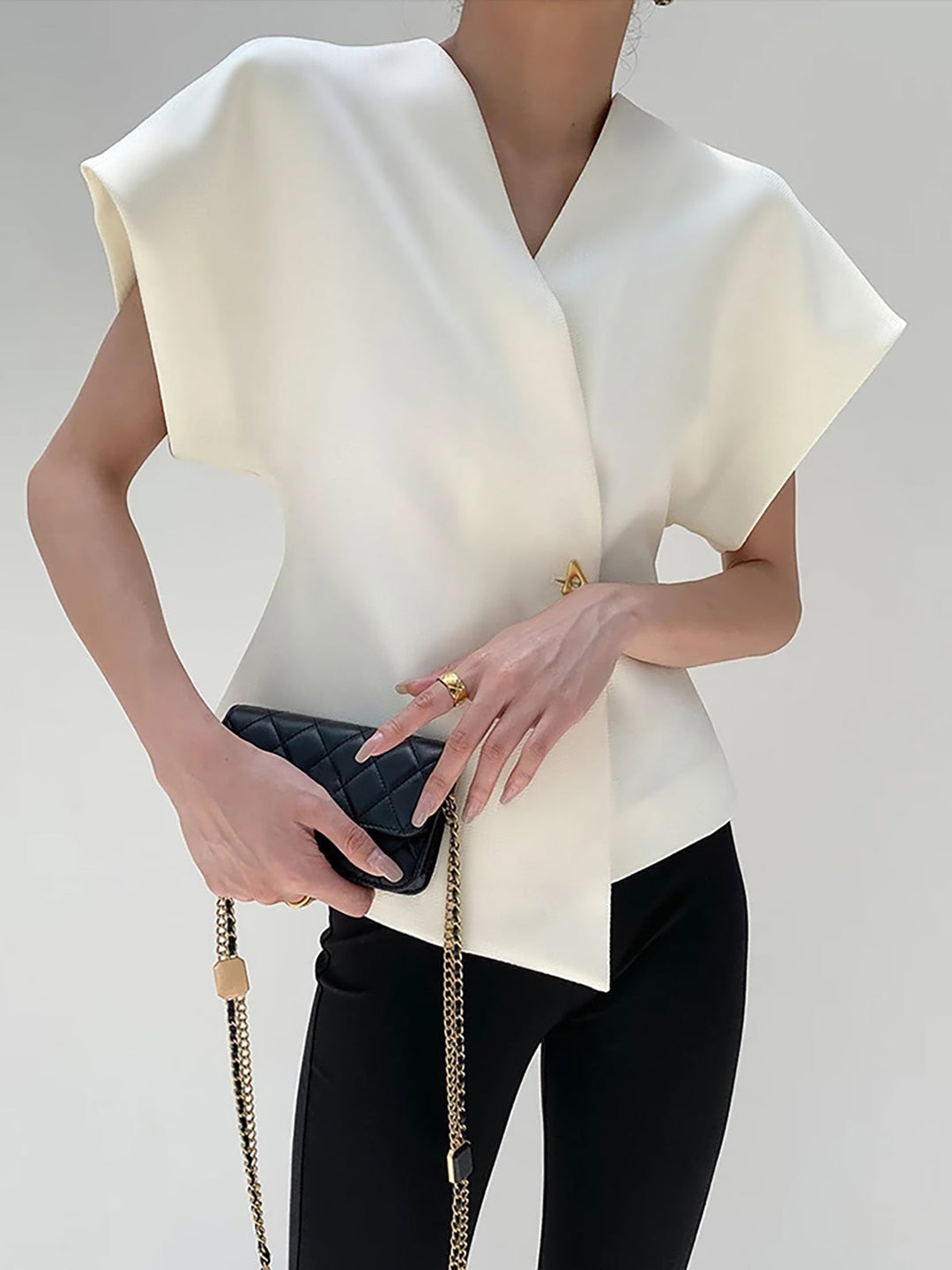 "Elegant women's V-neck blouse with buttons, tailored fit, chic button-down design, ideal for versatile stylish outfits."