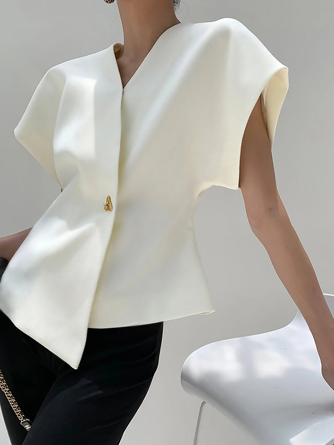 "Elegant women's V-neck blouse with buttons, tailored fit, chic button-down design, ideal for versatile stylish outfits."