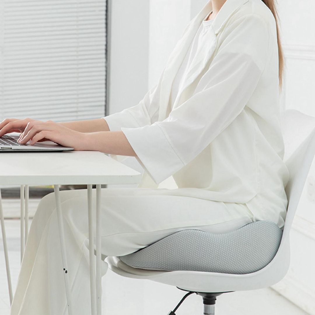 "Ergonomic memory foam sit bone relief cushion for office or car, contoured for tailbone support, adjustable firmness."