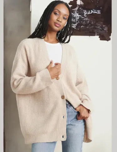 Front view of a soft, stylish women's cashmere cardigan in beige, showcasing its elegant, timeless silhouette for layering.