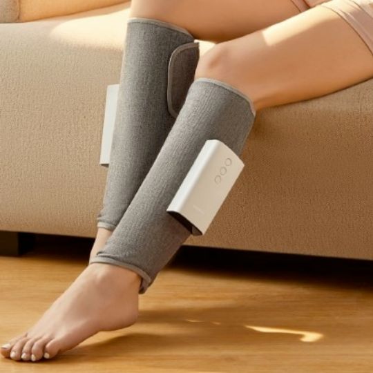 "Heated leg massager wraps around calves and ankles, shown in use. Provides soothing heat and customizable massage for relaxa