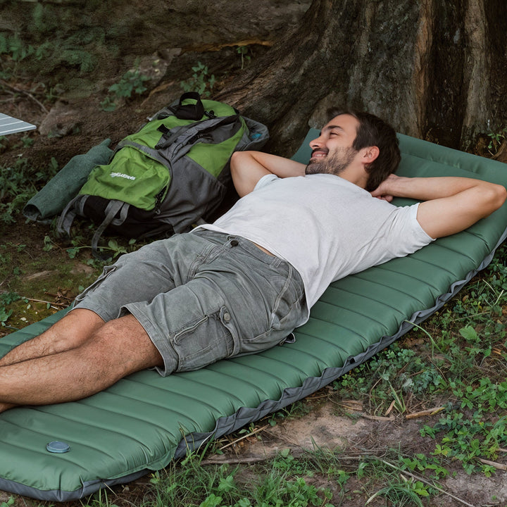 "Inflatable camping mattress with foot pump, plush surface, forest green color, lightweight, ideal for outdoor adventures."