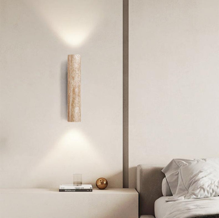 Japandi minimalist travertine stone wall lamp with natural beige finish, conveys elegance with its sleek design and warm glow