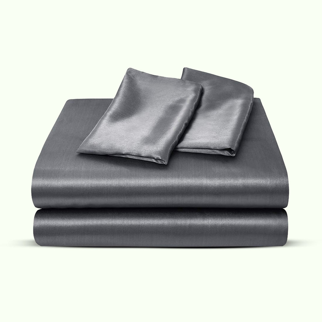 "Luxurious full size satin sheets with deep pockets, silky sheen in elegant colors, draped beautifully on a bed."