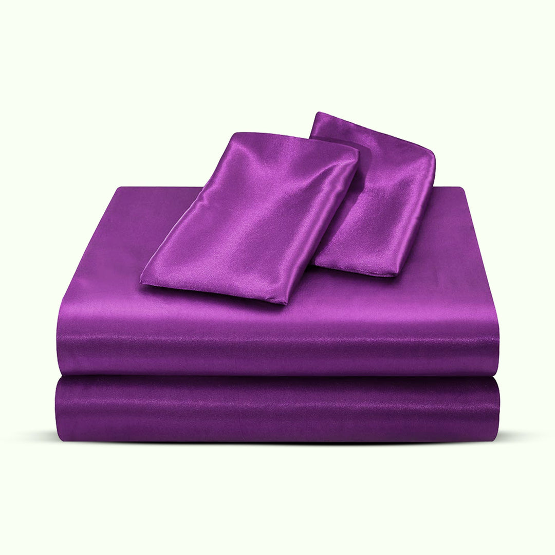 "Luxurious full size satin sheets with deep pockets, silky sheen in elegant colors, draped beautifully on a bed."