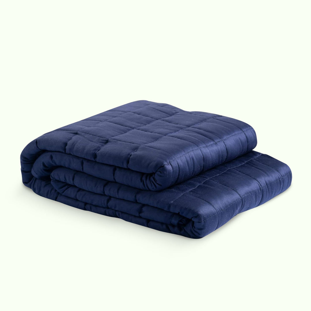 "Luxury weighted blanket with soft texture in blue and grey, designed for relaxation and enhancing sleep quality."