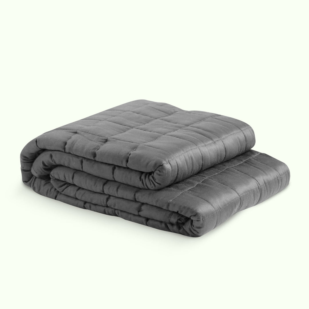 "Luxury weighted blanket with soft texture in blue and grey, designed for relaxation and enhancing sleep quality."