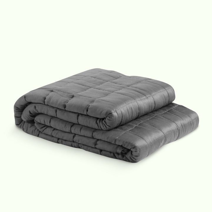"Luxury weighted blanket with soft texture in blue and grey, designed for relaxation and enhancing sleep quality."