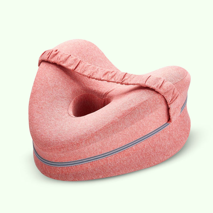 "Memory foam leg and knee support pillow in grey, pink, and white for pain relief, shown in various color options."