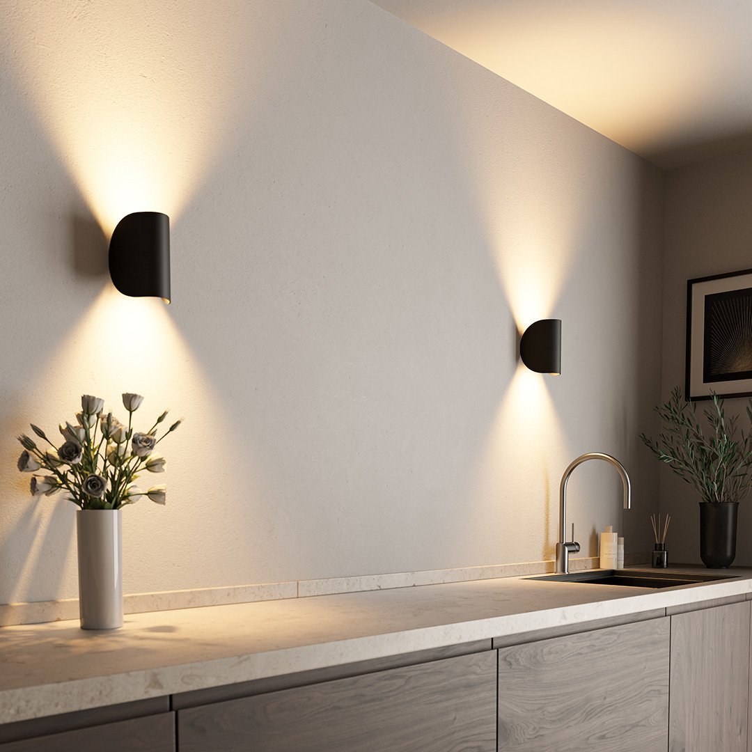 Modern LED up-down wall sconce light in black and white with minimalist design, perfect for indoor ambient lighting.