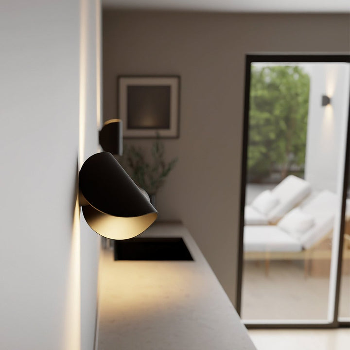 Modern LED up-down wall sconce light in black and white with minimalist design, perfect for indoor ambient lighting.