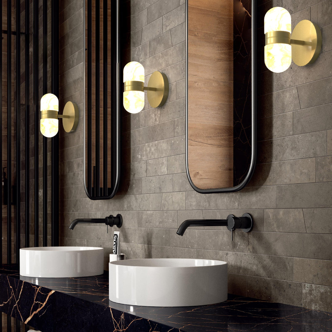 Modern brass wall lamp featuring snow-white alabaster shades with brown veining; elegant indoor lighting fixture.