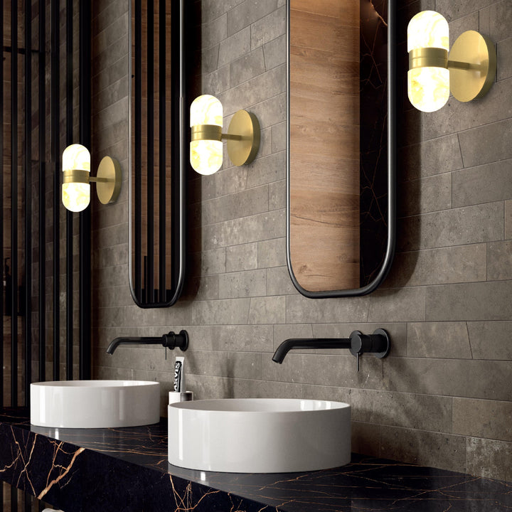 Modern brass wall lamp featuring snow-white alabaster shades with brown veining; elegant indoor lighting fixture.