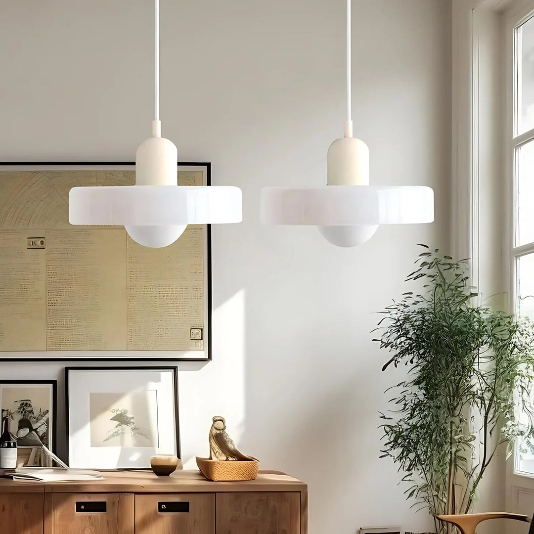 "Modern glass pendant light with sleek glass, brushed metal, ideal for elegant interiors, adds sophistication and warmth."
