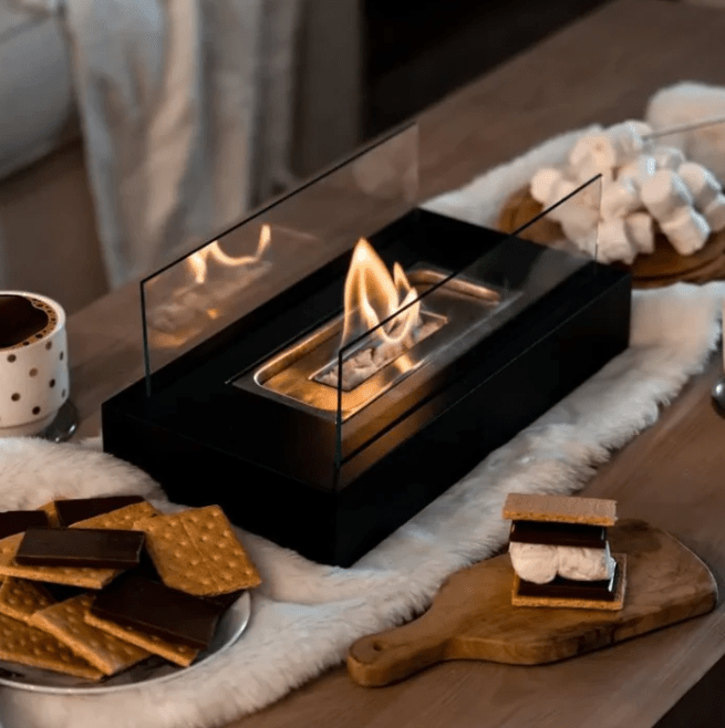 "Modern portable rectangular tabletop fire pit with real flame, sleek black design, tempered glass, and stainless steel body.