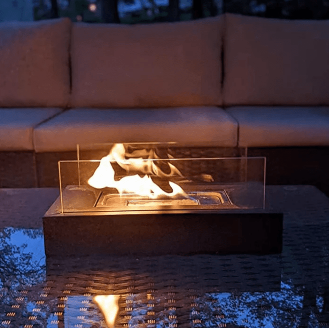"Modern portable rectangular tabletop fire pit with real flame, sleek black design, tempered glass, and stainless steel body.