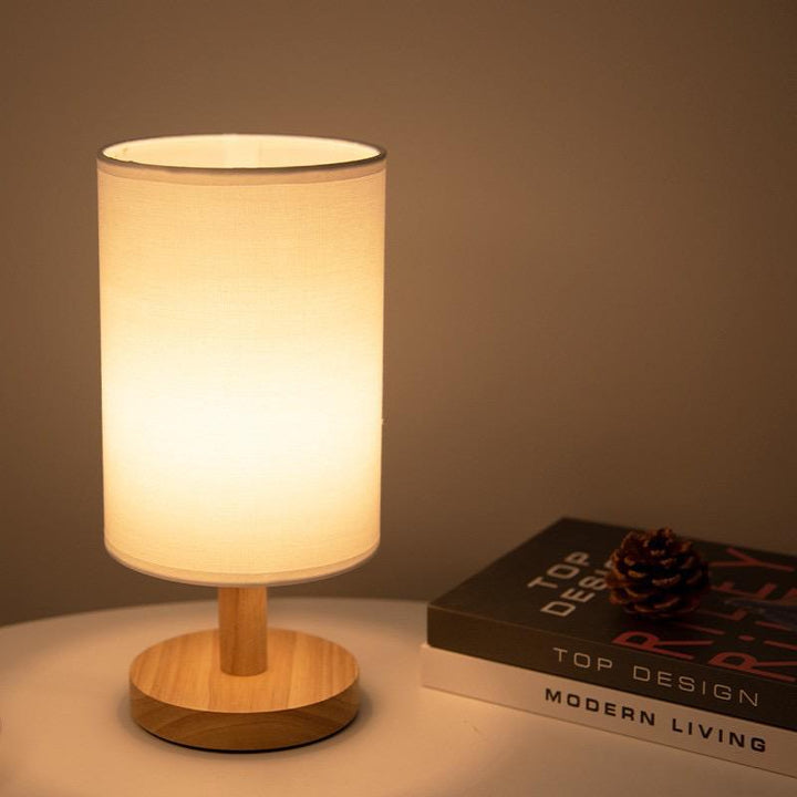 "Modern wooden bedside table lamp with remote, dimmable LED, natural wood look, elegant design for bedroom or living room."